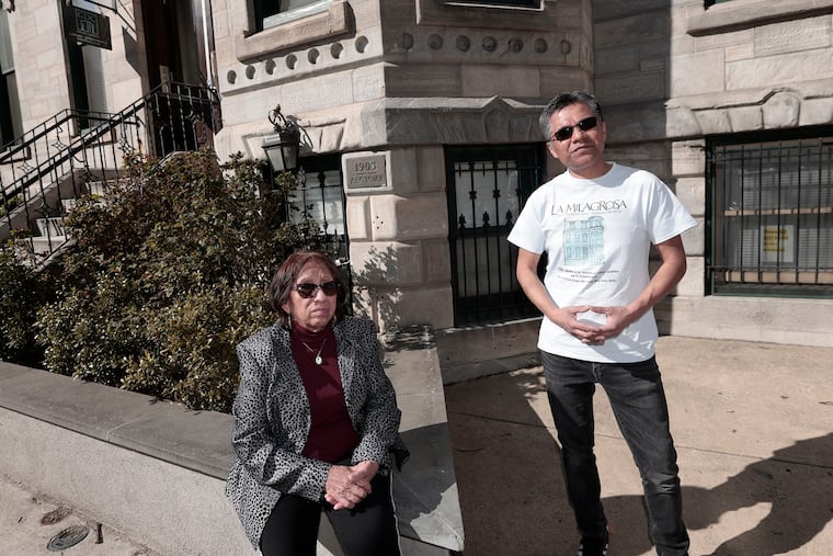 Mercedes Reyes (seated) and Miguel Ortiz in front of the former La Milagrosa Catholic Chapel at 1903 Spring Garden St. in Phila., Pa. on Sun., March 26, 2023. The property is now a condo.