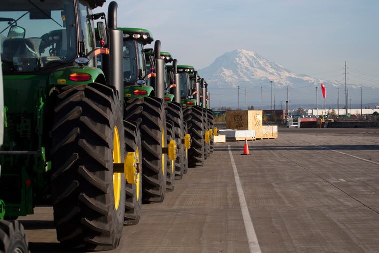 FILE - In this Nov. 4, 2019 file photo, John Deere tractors made by Deere & Company are shown as they are readied for export to Asia at the Port of Tacoma in Tacoma, Wash. The U.S. trade deficit fell in September 2020 after hitting a 14-year high in August as exports outpaced imports. The Commerce Department reported, Wednesday, Nov. 4, 2020, the gap between what the U.S. sells and what it buys abroad fell to 63.9 billion in September, a decline of 4.7% from a $67 billion deficit in August.