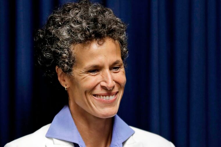 Bill Cosby accuser Andrea Constand smiles as she listens during a news conference after Cosby was found guilty in his sexual assault retrial.