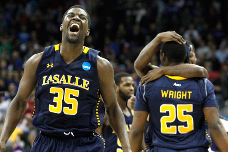 La Salle's Rohan Brown celebrates as Jerrell Wright is hugged in background after they defeated Kansas State. (Ron Cortes/Staff Photographer)