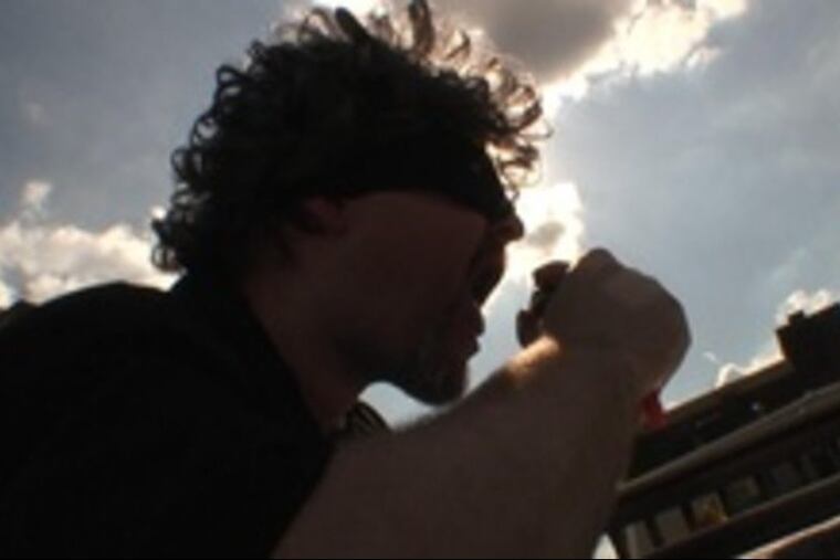 A masked Craig LaBan sings about cheeseburgers.