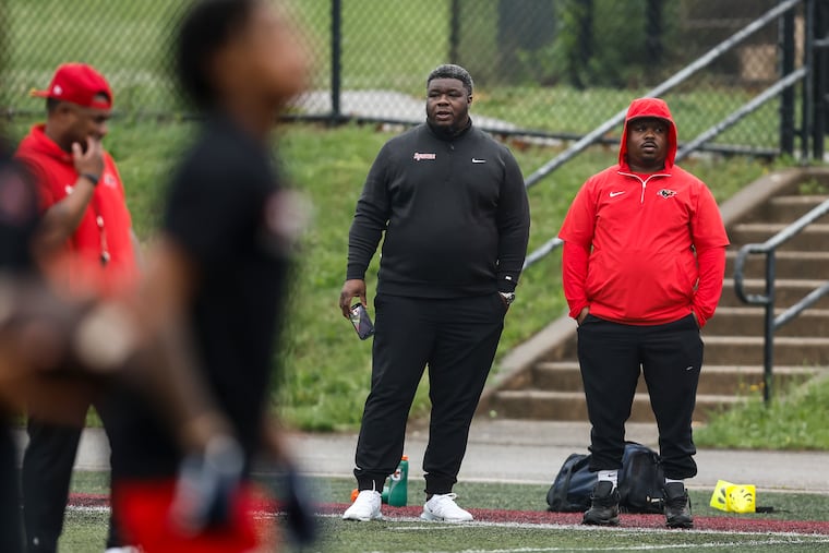 Elijah Robinson, Syracuse's defensive coordinator, watches an Imhotep Charter showcase for recruiters and media on May 14.