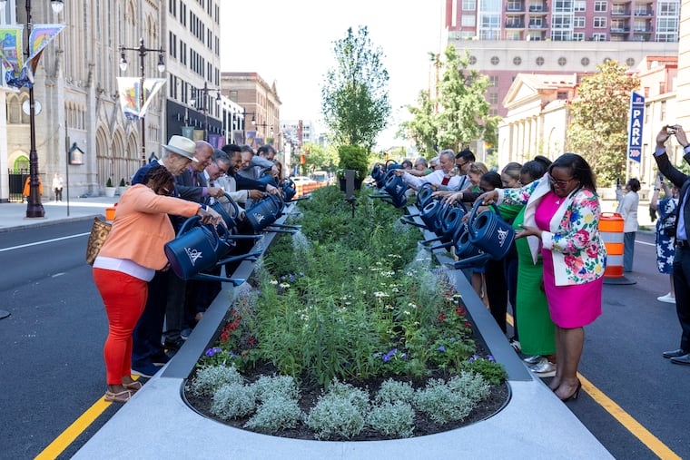 Attendees watering the new redesign of the South Broad Street median outside the Kimmel Center in Philadelphia, Pa., on Wednesday, June 24, 2026.