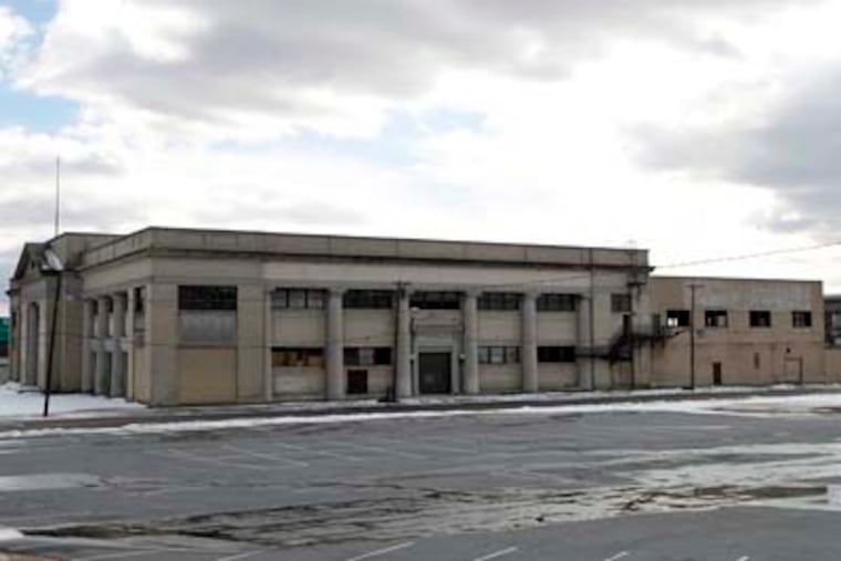 The Campbell Soup Co. headquarters, background at right, can be seen in Camden, N.J., Tuesday, Feb. 8, 2011, near an old Sears department store building, which closed 40 years ago. The Campbell Soup Co. wants to knock down the Sears building to make way for an office park. But a group of activists, saying the 1920s building has historical value, has been fighting for years to keep the building near the Campbell headquarters intact. A judge is expected to rule Tuesday on the case involving the two Camden icons. (AP Photo/Mel Evans)