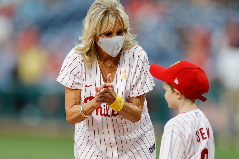 First Lady Dr. Jill Biden claps with Sean Kennedy during the childhood cancer awareness night before the Phillies played the Washington Nationals on Friday.