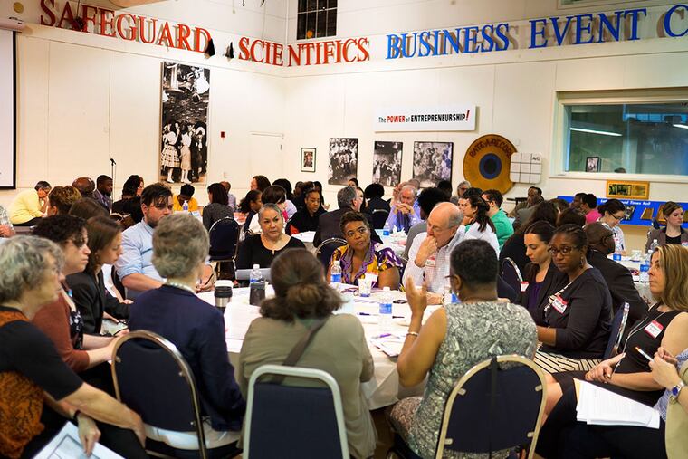 A diverse group of civic minded people made up of Federal, State and Local officials, financial wizards, educators community organizers and locals gather at The Enterprise Center in West Philly as part of the Promise Zone initiative, a plan to fix Mantua, a broken neighborhood. Here, scission groups form to discuss Promise Zone problems and solutions on May 28, 2014. ( ED HILLE / The Philadelphia Inquirer )