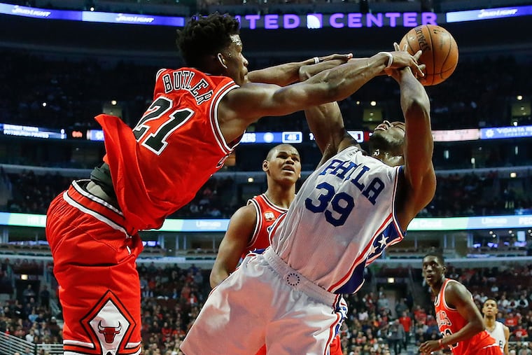 Chicago Bulls guard Jimmy Butler (21) fouls Philadelphia 76ers forward
Jerami Grant (39) during the first half of an NBA basketball game Wednesday, April 13, 2016, in Chicago.
