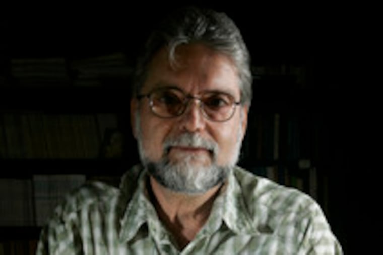 Professor Anthony Ranere of Temple's anthropology department, with the stone tools that carried evidence of domesticated plants.