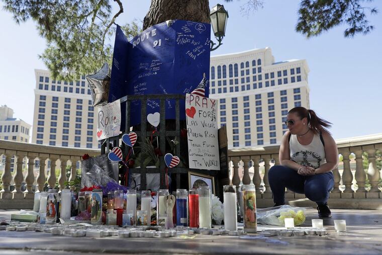 Allison Easterbrooks pauses Wednesday at a memorial for the people killed in the mass shooting in Las Vegas.