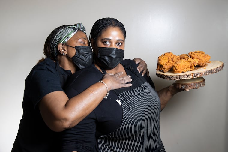 Abbygale Bloomfield (right) with her mother, Sandra Brown, and their jerk fried chicken at Kingston 11.