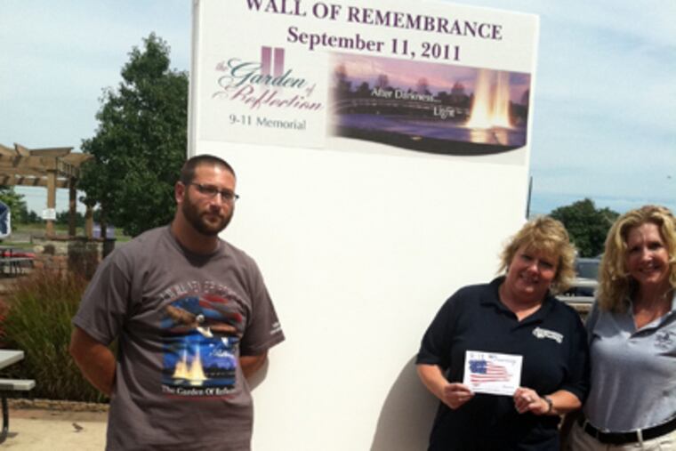 The Garden of Reflection's Wall of Remembrance, with builder Andrew Cerasi, Shady Brook Farm’s Eve Moody (center), and program director Valerie Mihalek. It will be unveiled Saturday in Lower Makefield. (Bill Reed / Staff)