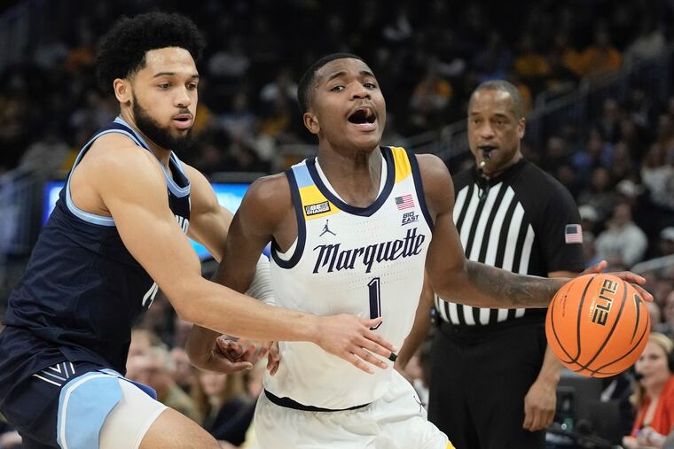 Marquette's Kam Jones tries to get past Villanova's Caleb Daniels during the first half action between the Wednesday in Milwaukee. Marquette prevailed, 73-64.