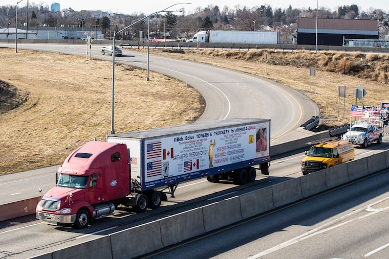A Pennsylvania truck protest convoy bound for the nations' capital organized by Scranton-area towing business owner Bob Bolus drives down I-83 South Wednesday, Feb. 23, 2022 in Lemoyne, Pa.. A small convoy of truckers demanding an end to coronavirus mandates began a cross-country drive from California to the Washington, D.C., area on Wednesday. (Sean Simmers/The Patriot-News via AP)