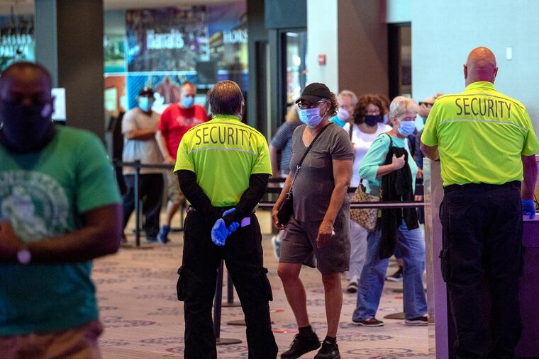 People lined up to enter the day that Harrah's Philadelphia Casino and Racetrack reopened in late June in Chester., after a COVID-19 shutdown. Public school buildings, meanwhile, have remained closed even months later.