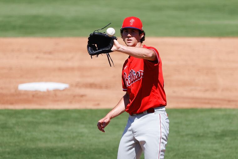 Phillies pitcher Andrew Painter catches the baseball in spring training.
