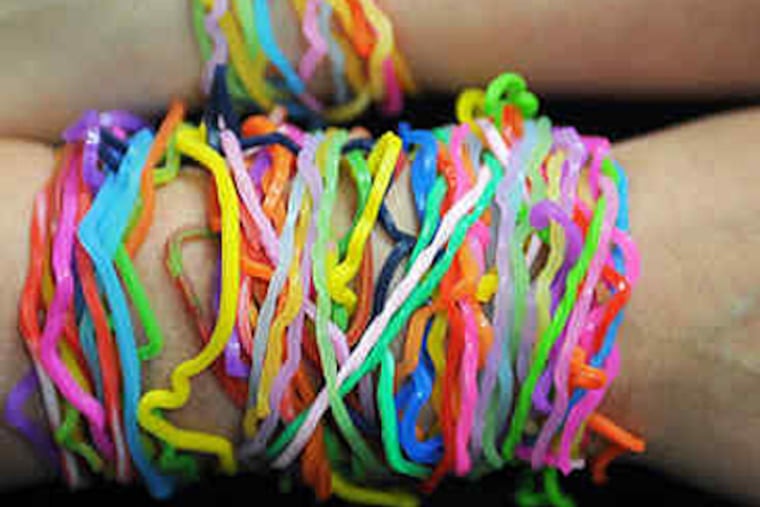 Josh Joffe, 10, has lots of bandz of different shapes and colors. Boys and girls love them, and wear them as bracelets. (Sharon Gekokski-Kimmel / Staff)
