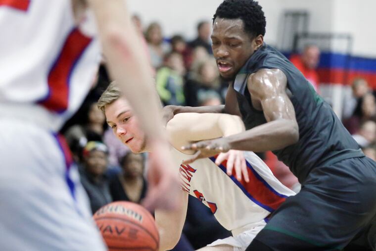Triton’s # 3 Colin Taylor (left) and West Deptford’s # 23 Elijah Malloy fight for a rebound during the West Deptford at Triton HS boys basketball game on January 25, 2019. West Deptford defeated Triton 64-39