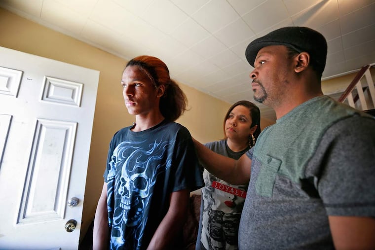 Romeo Glover with his parents, Fatima and Randy. The junior at Tacony Charter High School says he quietly endured bullying for months.