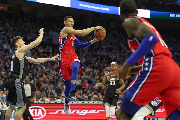 Ben Simmons (with ball) and teammate James Ennis III (right) will both miss Monday night's game.