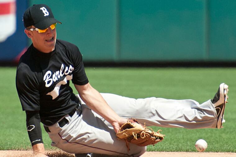The ball gets by Burlington County shortstop Joe Paolini. (Ron Tarver/Staff Photographer)