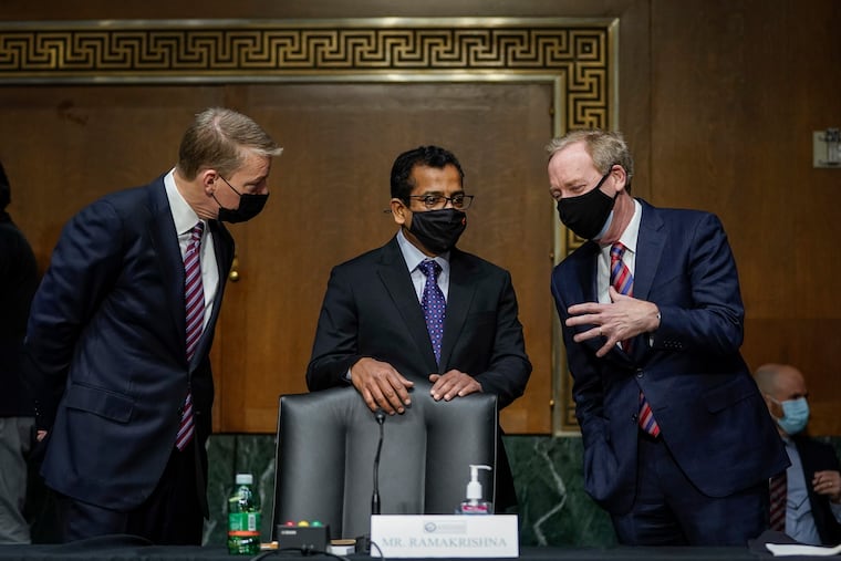 FireEye CEO Kevin Mandia, SolarWinds CEO Sudhakar Ramakrishna and Microsoft President Brad Smith talk before a Senate Intelligence Committee hearing on Capitol Hill on Tuesday, Feb. 23, 2021 in Washington. (Drew Angerer/Photo via AP)