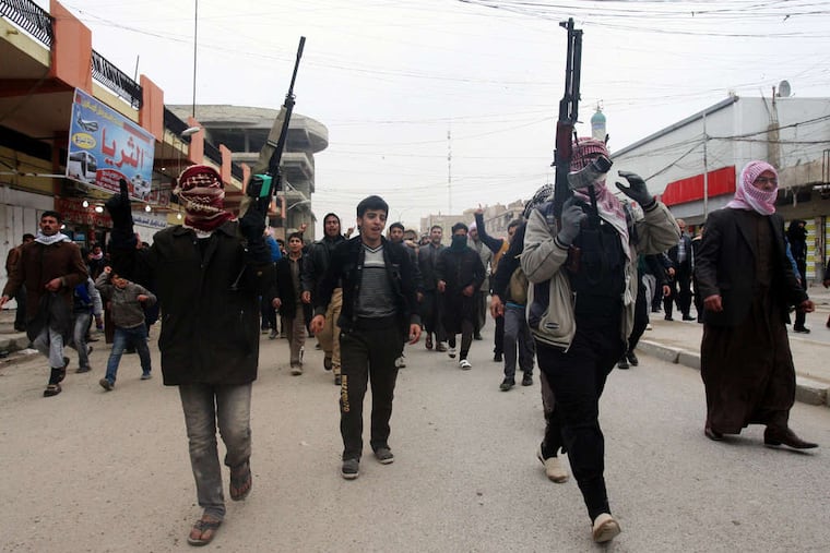Mourners and Sunni gunmen chant slogans against Iraq's Shiite-led government during the funeral of a man killed during fighting between al-Qaeda gunmen and the Iraqi army in Fallujah on Friday.
