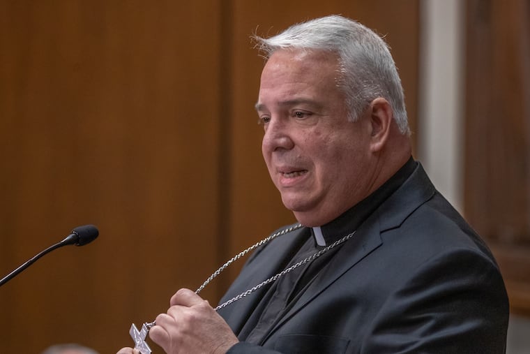 Bishop Nelson J. Perez, who was named to lead the Philadelphia Archiocese, holds the crucifix that hangs around his neck. It was given to him by Archbishop Charles J. Chaput, when he was first made a bishop.