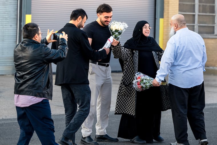 Emine Emanet is reunited with her husband, Celal Emanet, (right) as she leaves the Elizabeth Detention Facility on Wednesday, two weeks and a day after the couple were arrested at their Haddon Township restaurant. At left are their son Muhammed Emanet (center) and family friends Abdullah Sezikli (left) and Mustafa Tug (second from left).