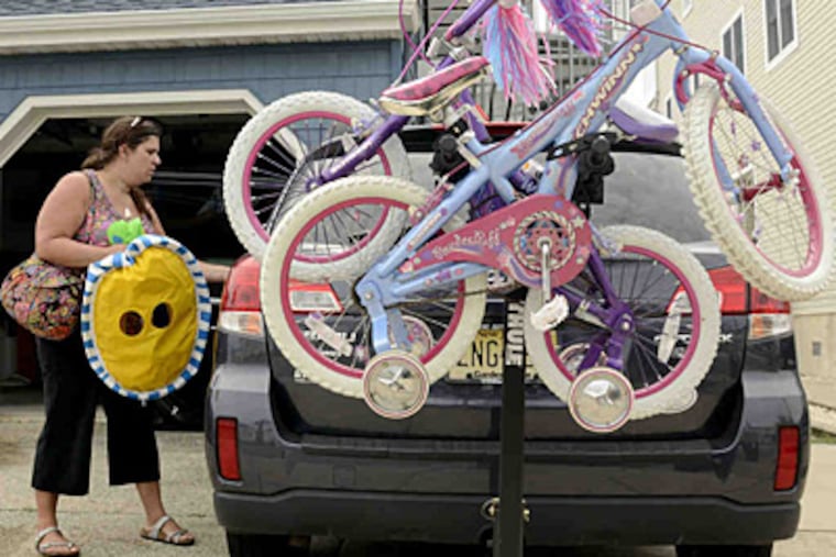 Before leaving her parents' house at Sea Isle City after Labor Day weekend, Stephanie Metcalf packs her SUV. Monday was her family's last time at the Shore before school starts.