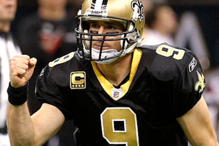 Saints quarterback Drew Brees finished broke Dan Marino's 1984 single-season passing record of 5,084 yards. (Bill Haber/AP Photo)