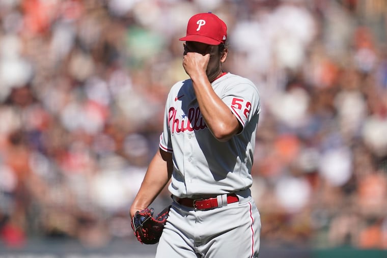 Phillies pitcher Brad Hand reacts after walking the Giants' Joc Pederson with the bases loaded during the sixth inning on Saturday.