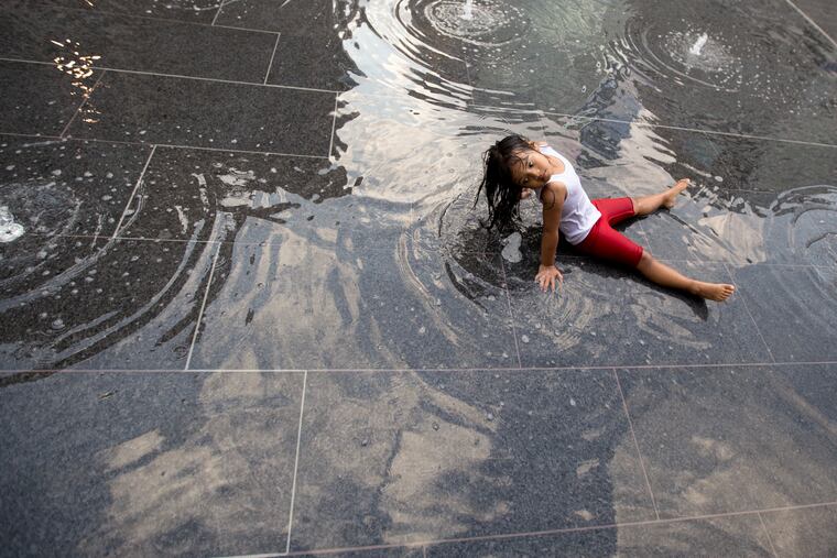 Kimberly Theo, then 4, sits in the fountain at Dillworth Plaza during a hot day in 2016.