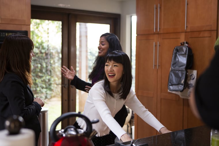 Marie Kondo (foreground), star of Netflix's "Tidying Up with Marie Kondo," with Shehnita (behind her), who hopes that a tidier home will help make room for a third child. Kondo's interpreter, Marie Iida, is at left.