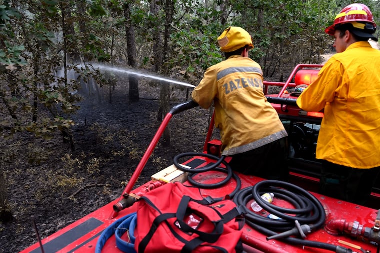 File: Firefighters monitoring hot areas after a June 2022 fire in Wharton State Forest. A fire that broke out April 24, 2024, reached 500 acres before it was fully contained.