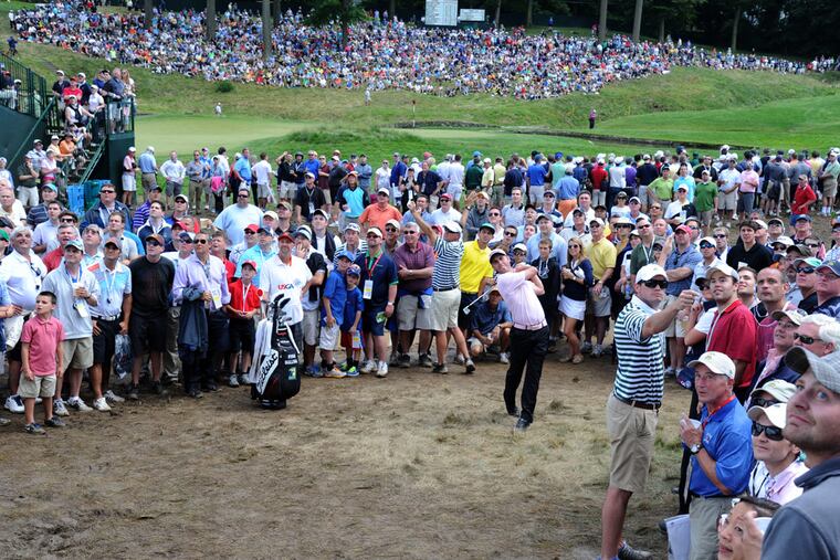 Ryan Sullivan makes a shot from a wayward position between the fourth and ninth fairways during the U.S. Open at Merion on June 14, 2013.