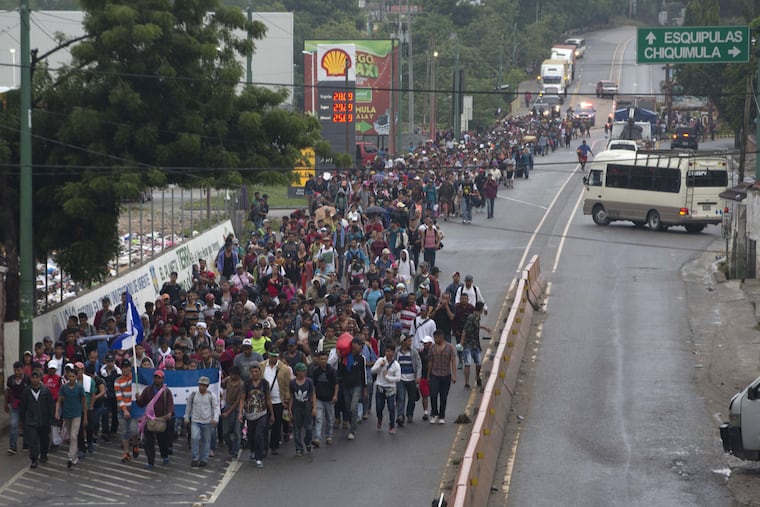 Honduran migrants walking toward the U.S. depart Chiquimula, Guatemala, last Wednesday. The group of some 2,000 Honduran migrants hopes to reach the United States despite President Trump's threat to cut off aid to Central American countries that don't stop them.