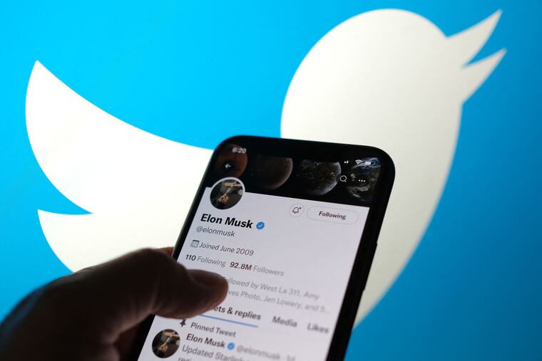 This illustration photo displays Elon Musks Twitter account with a Twitter logo in the background.