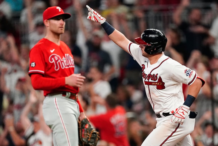 The Braves’ Austin Riley gestures as he runs past the Phillies' Brad Miller in the fourth inning after hitting a solo home run Thursday night.