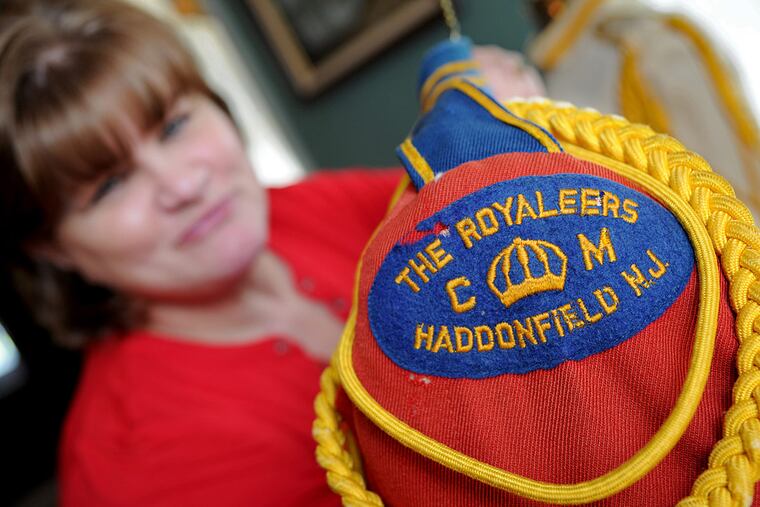 Former Royaleer Terri Brennan displays the shoulder epaulet from the uniform she used to wear.