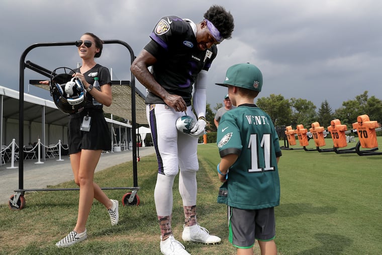 The Ravens' Robert Griffin III signs an autograph for Eagles fan Will Tashlik, 5, of Media, after a joint practice with the Eagles.