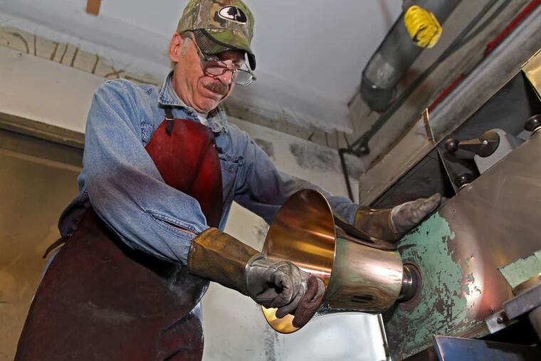 Tony Amanero, polisher at Schulmerich Carillons, puts a shine on the interior of a bell in 2018. The Hatfield company's owner, attorney Jonathan Goldstein, argues in a federal lawsuit that Pennsylvania Gov.Tom Wolf has the right to shut down businesses to fight coronavirus, but has not offered either Constitutionally-required compensation, nor a "due process" for appealing decisions of a process he says appears arbitrary