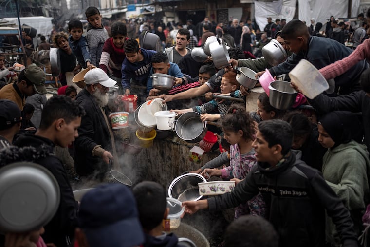 Palestinians line up for a free meal in Rafah, Gaza Strip on Thursday.