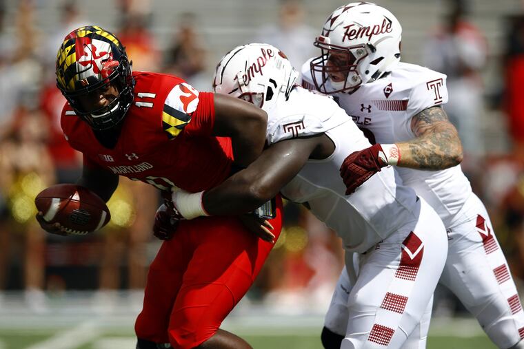 Maryland quarterback Kasim Hill, left, getting sacked by Temple defensive tackle Michael Dogbe, center, and defensive end Jimmy Hogan during the teams' game last September.