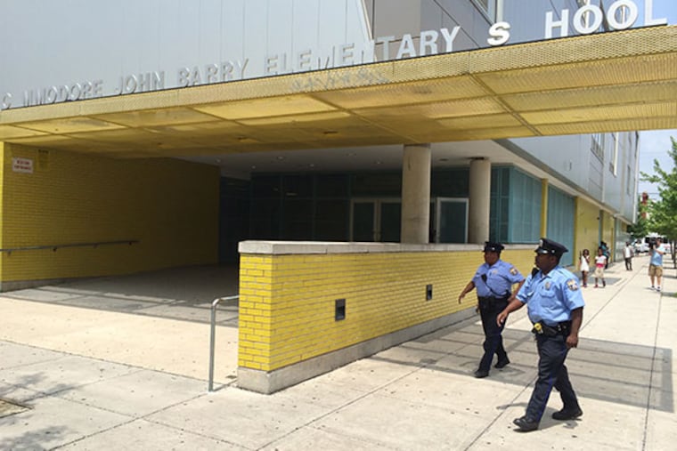 Police respond to a report of a child with unknown substance at Commodore John Barry Elementary School at 59th and Race Streets in Philadelphia. (Alejandro Alvarez/Staff Photographer)