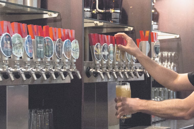 A bartender at the Victory Brewing Company in Downingtown pours a Victory beer for a customer. (RACHEL WISNIEWSKI/Staff Photographer)