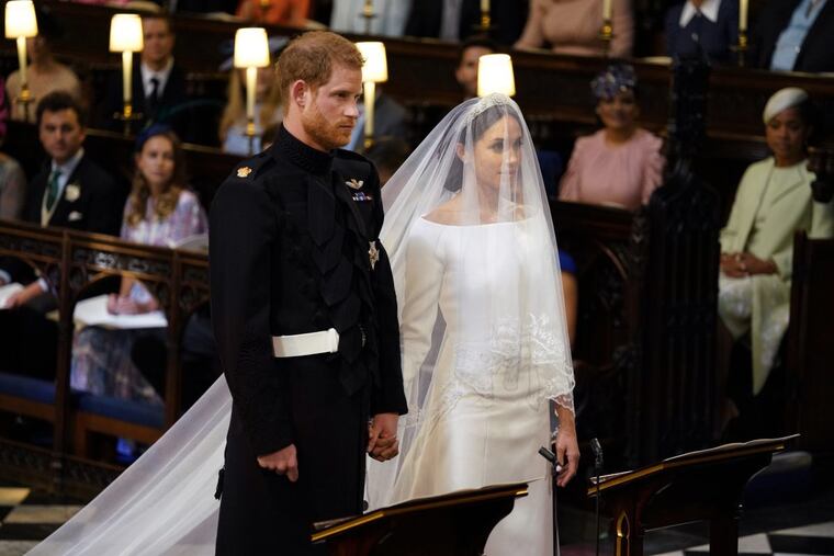 Britain's Prince Harry and Meghan Markle stand, prior to the start of their wedding ceremony, at St. George's Chapel in Windsor Castle in Windsor, near London, England, Saturday, May 19, 2018. (Dominic Lipinski/pool photo via AP)