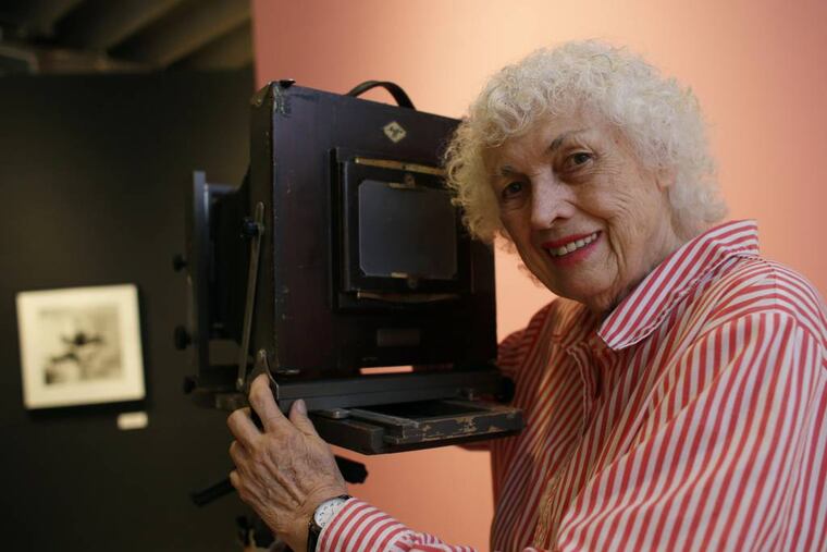 FILE - In this April 23, 2013 file photo, photographer Bunny Yeager poses with a camera similar to one used when she worked as a photographer in the 50's and 60's at the Bunny Yeager Studio in Miami. Yeager, a model turned photographer most famous for photographing Bettie Page in the 1950s, died Saturday, May 24, 2014, at a Delray Beach hospice. She was 85 years old. (AP Photo/Lynne Sladky, File)