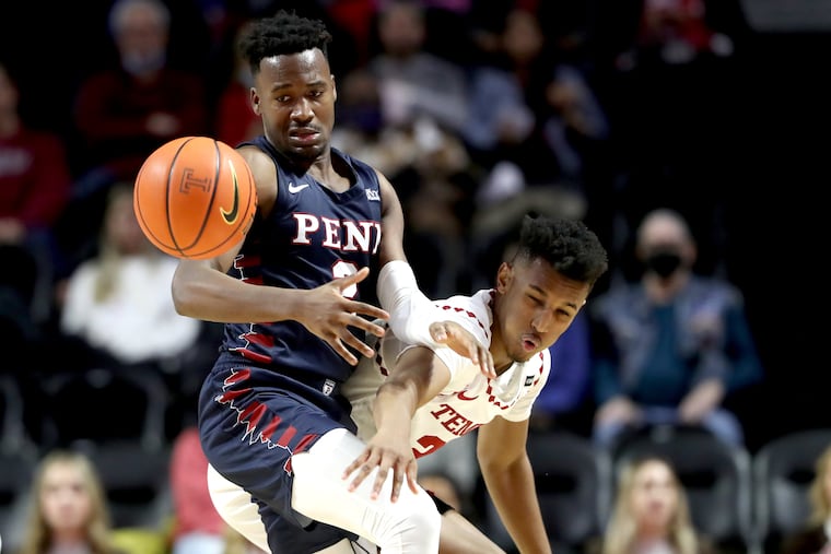 Zach Hicks (right) of Temple deflects the ball away from Jonah Charles of Penn during the 1st half at the Liacouras Center on Dec. 4, 2021.