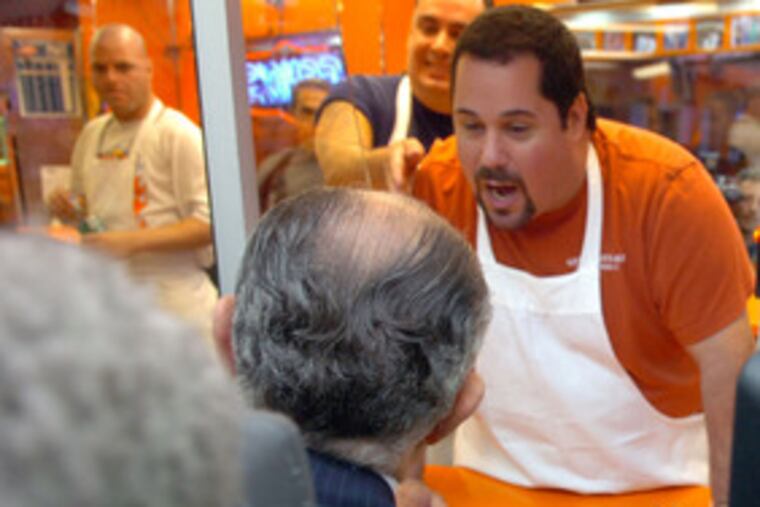 GOP presidential candidate Rudy Giuliani gives his cheesesteak order to Geno Vento at Geno's Steaks in S. Phila.