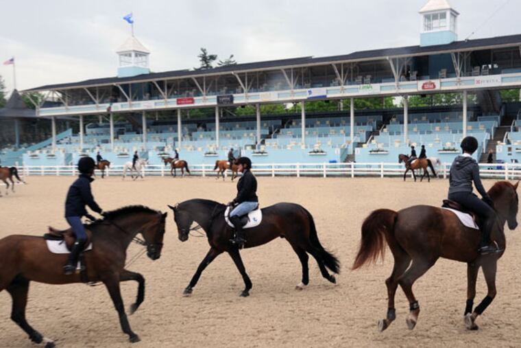 Horses and riders warm up for the 2014 Devon Horse Show. (CLEM MURRAY / Staff Photographer)